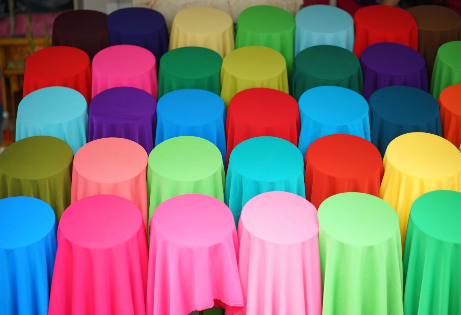 Textiles and Apparel on multiple round tables.